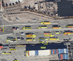 A aerial view of a road with many trucksAI-generated content may be incorrect.